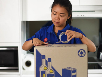 woman looking at her lilyfield box that requires expert packing and unpacking services