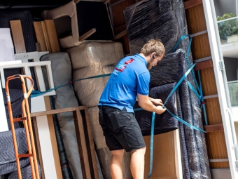 two abc removalists dulwich hill holding furniture that moves to their removal truck